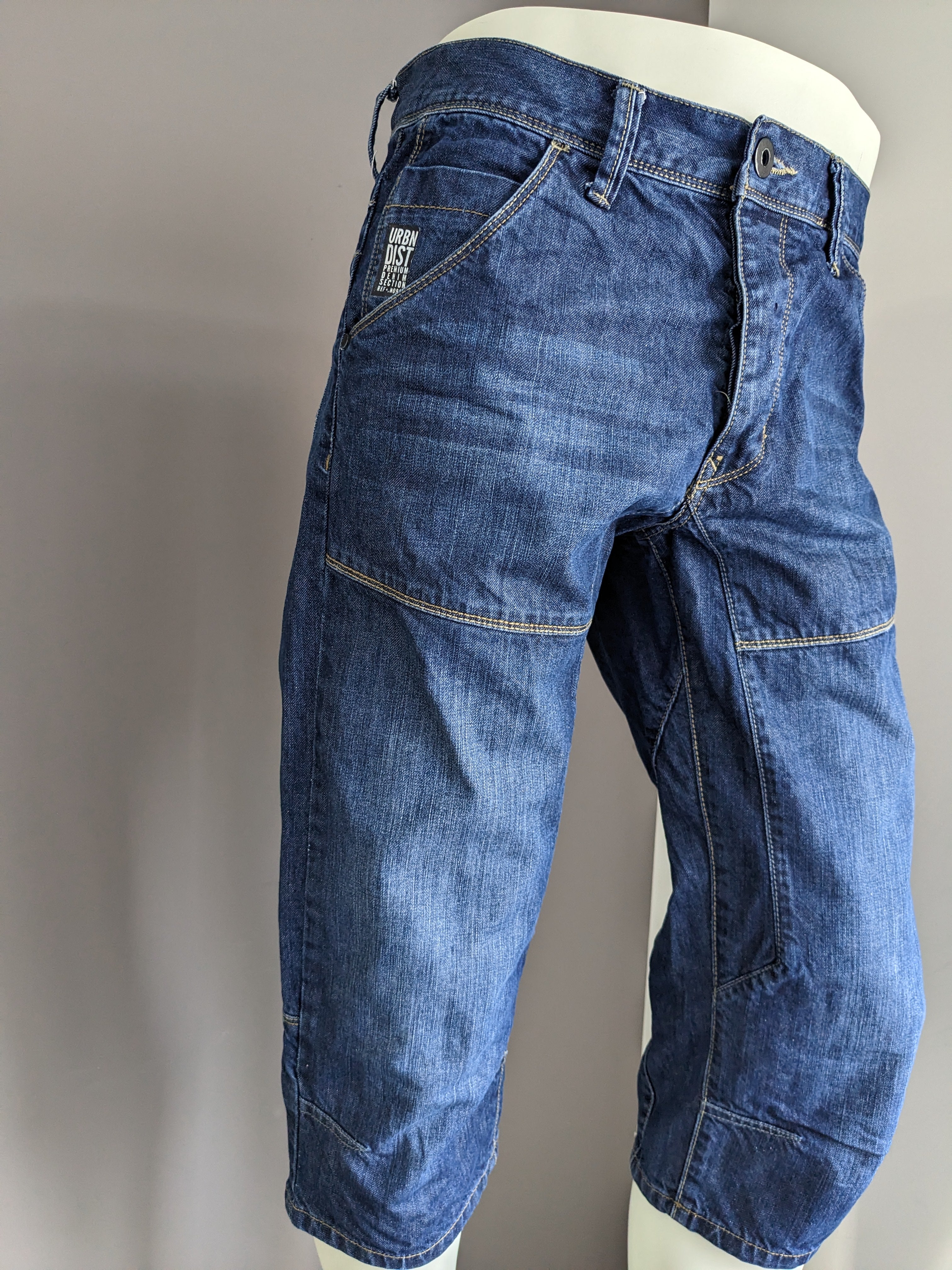 Urban district 3/4th shorts of jeans fabric. Dark blue colored