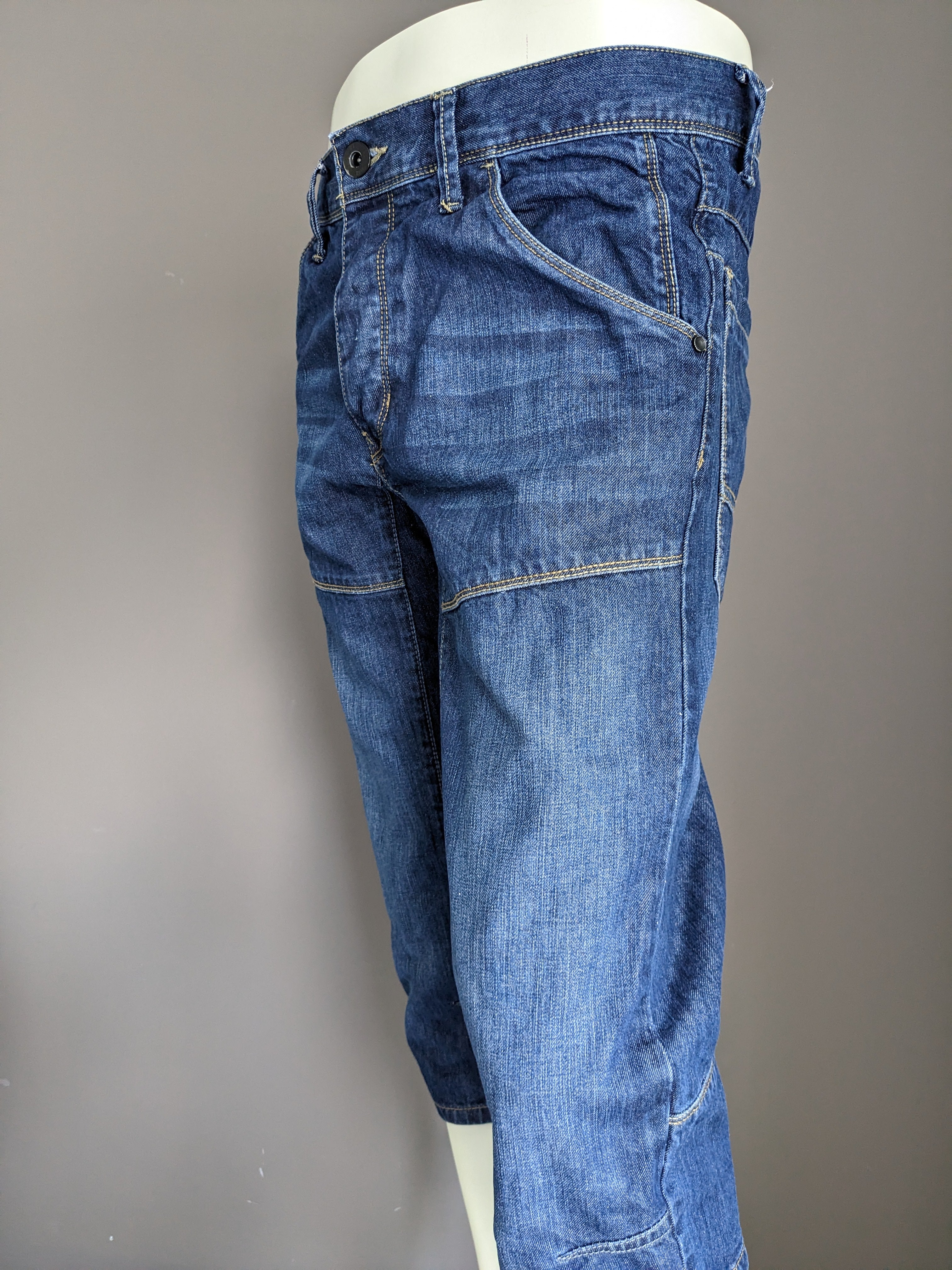 Urban district 3/4th shorts of jeans fabric. Dark blue colored