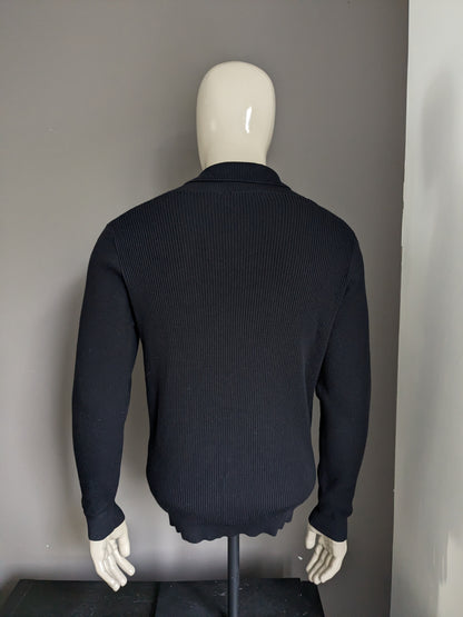 Blue industry sweater with sporty collar. Black rib motif. Size M.