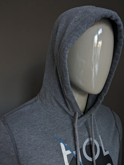 Hollister Hoodie. Donker Grijs gemêleerd met opdruk. Maat M.