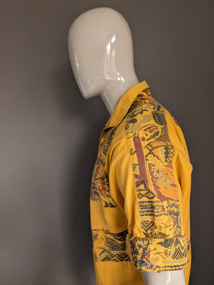 Vintage polo with elastic band. Dark yellow with print. Size L.