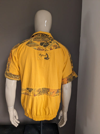 Vintage polo with elastic band. Dark yellow with print. Size L.