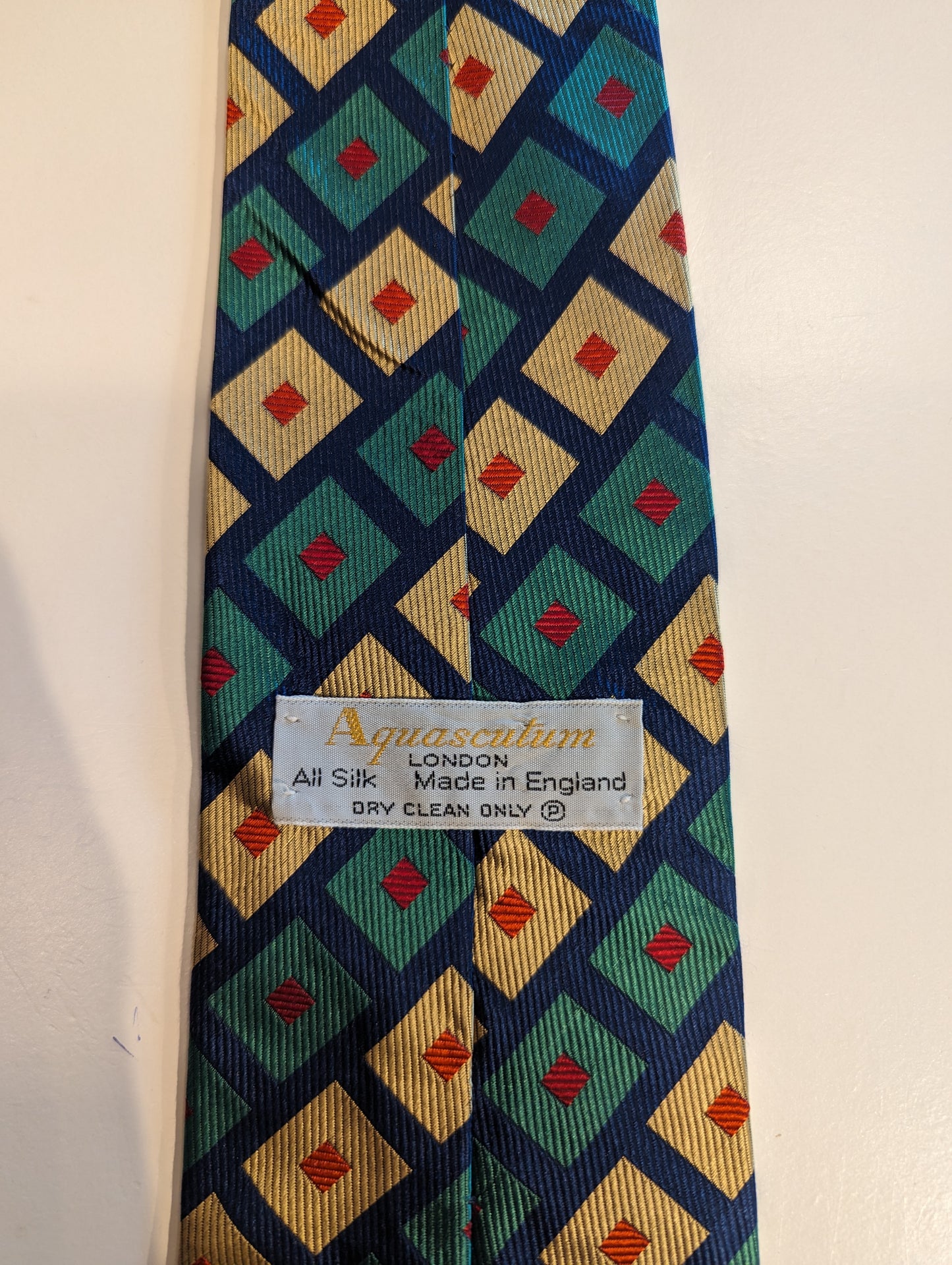 Vintage silk aquascutum designer tie. Green blue red motif.