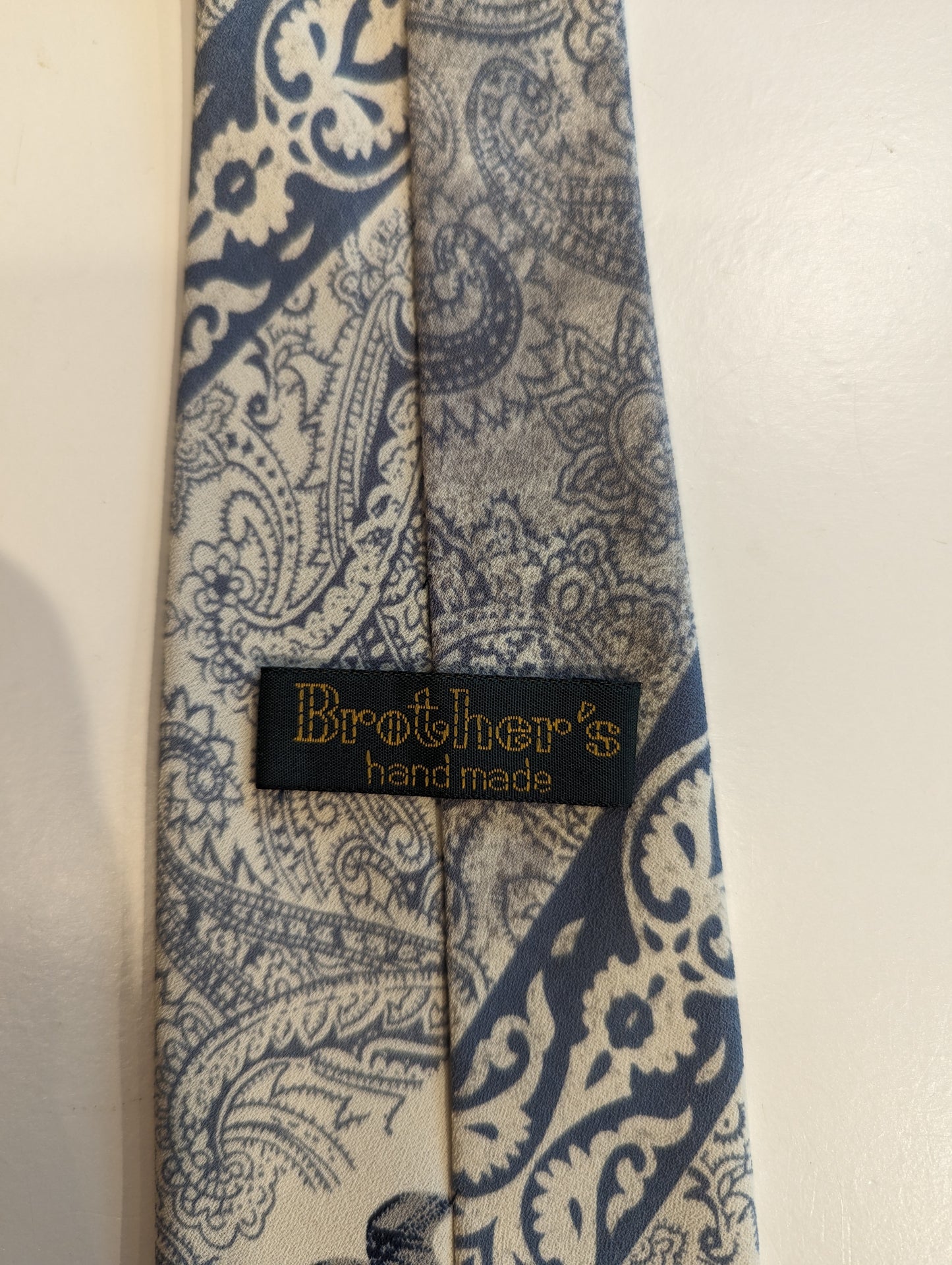 Vintage Brother's hand made polyester tie. Blue gray light brown motif.