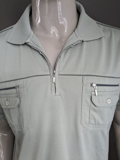 Vintage Hardline polo met elastische band en rits. Lichtgroen. Maat M / L.