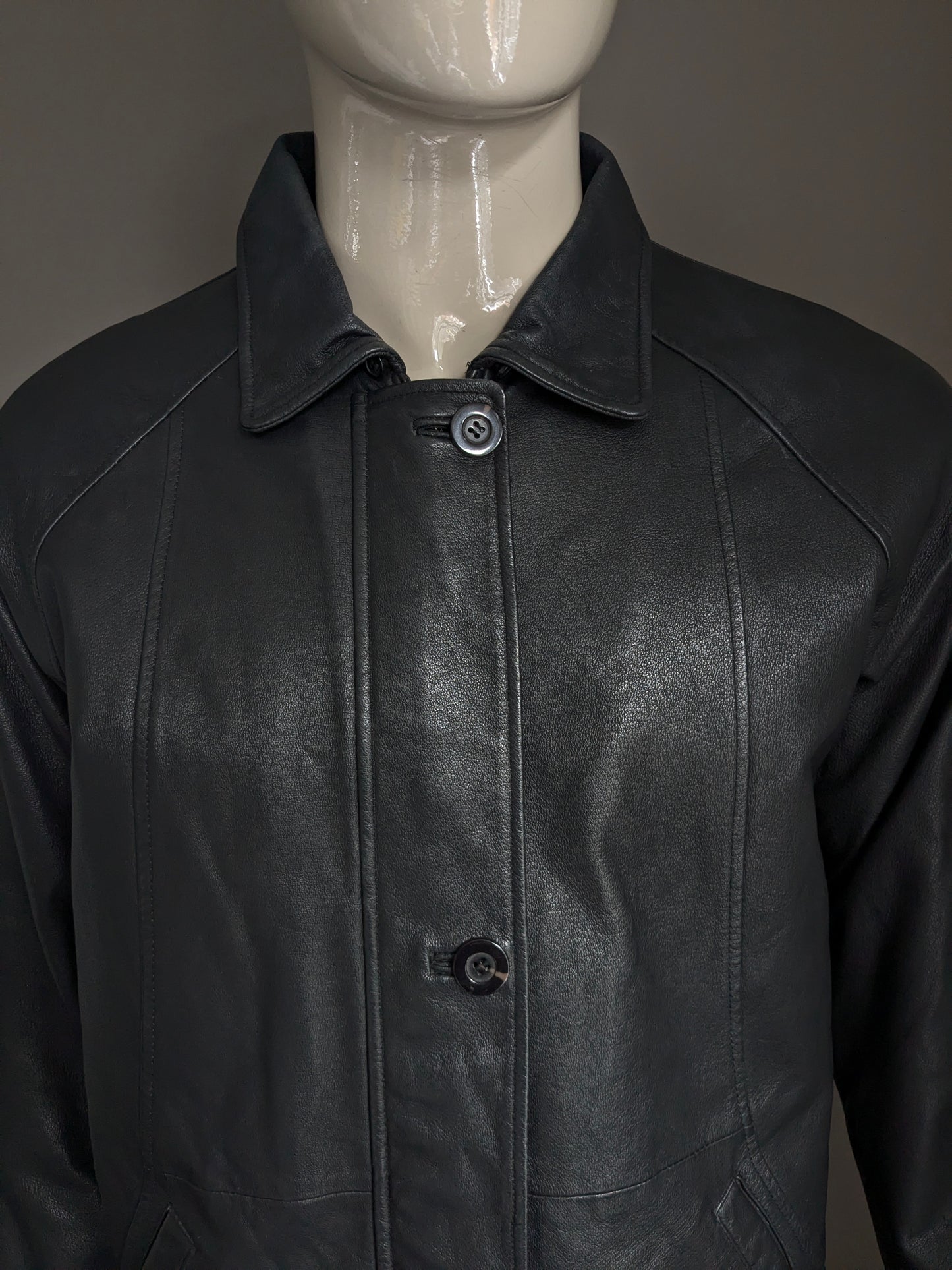 Donna D leather jacket with zip and button closure. Black colored. Size L.