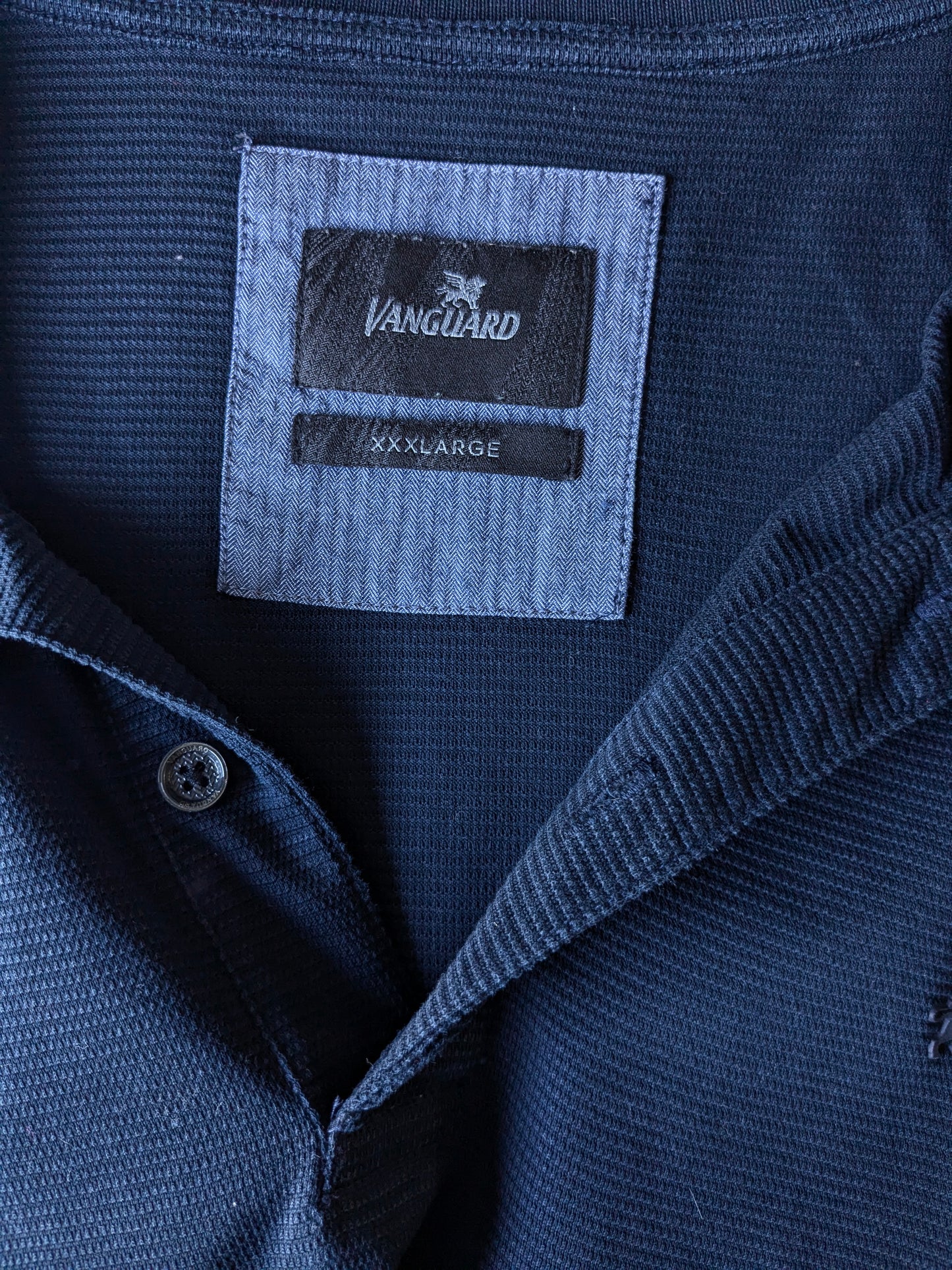 Vanguard Polo. Dark blue, slightly translucent striped motif. Size 3XL / XXXL.