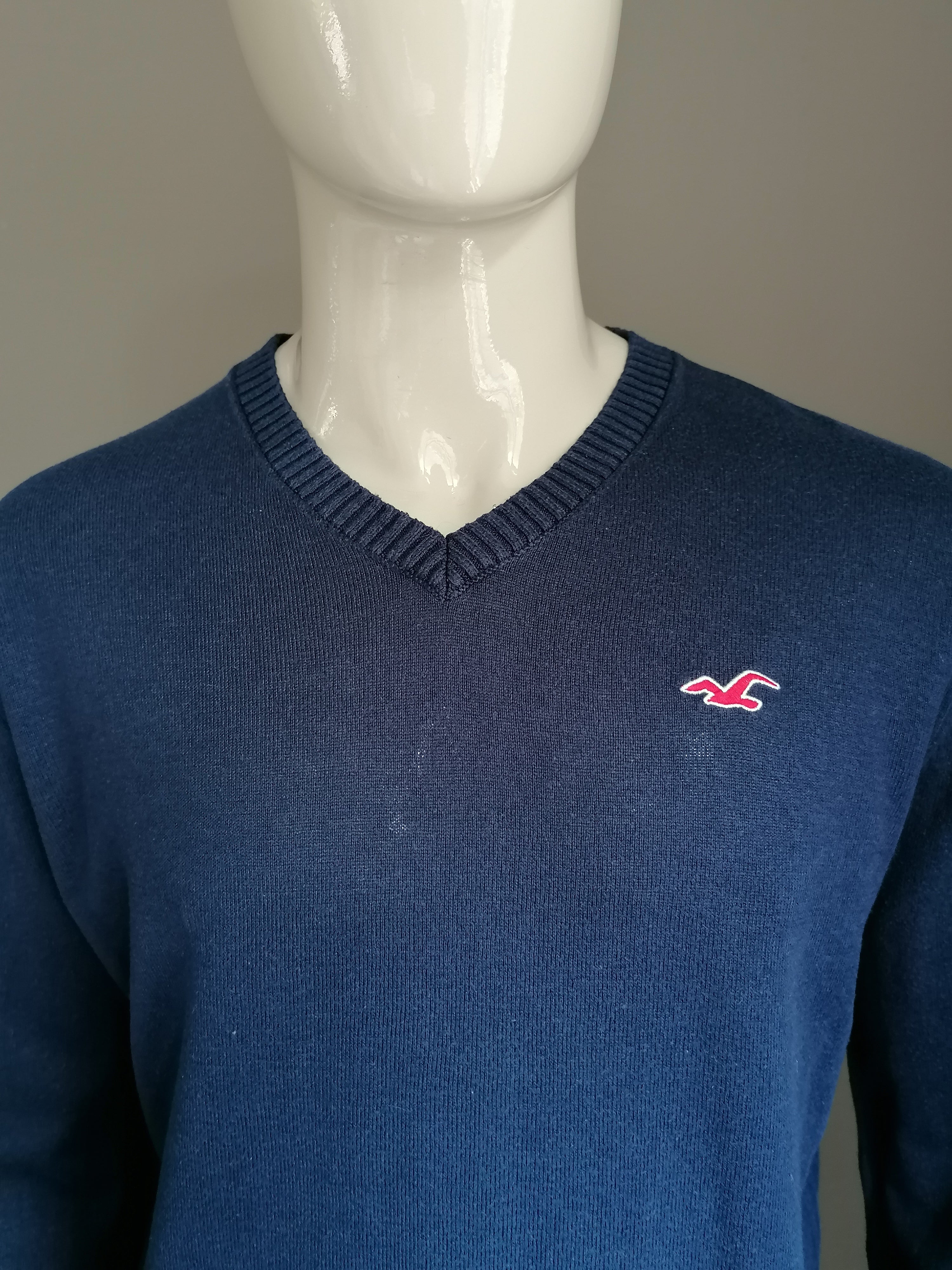 Pull hollister avec col en V. Couleur bleu fonc . Taille xl