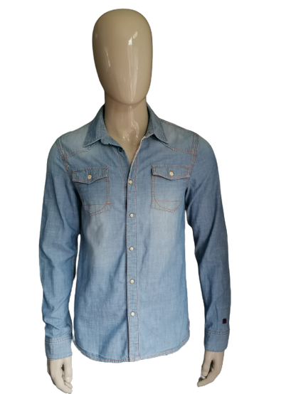 Rempille jeans / chemise en jean avec goujons de presse. Couleur bleue. Taille L.