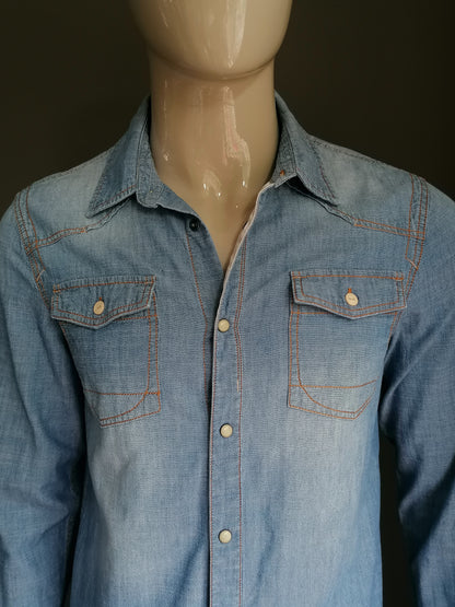 Rempille jeans / chemise en jean avec goujons de presse. Couleur bleue. Taille L.